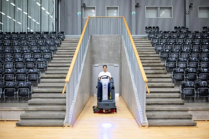 scrubber positioned in an arena concourse entry area
