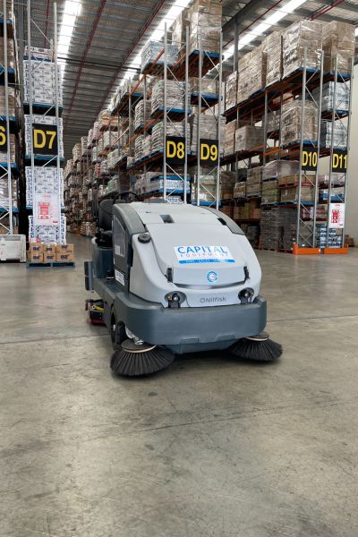 Nilfisk CS7010 Sweeper Scrubber Cleaning Warehouse Aisles Nilfisk CS7010 Sweeper Scrubber Cleaning Warehouse Aisles